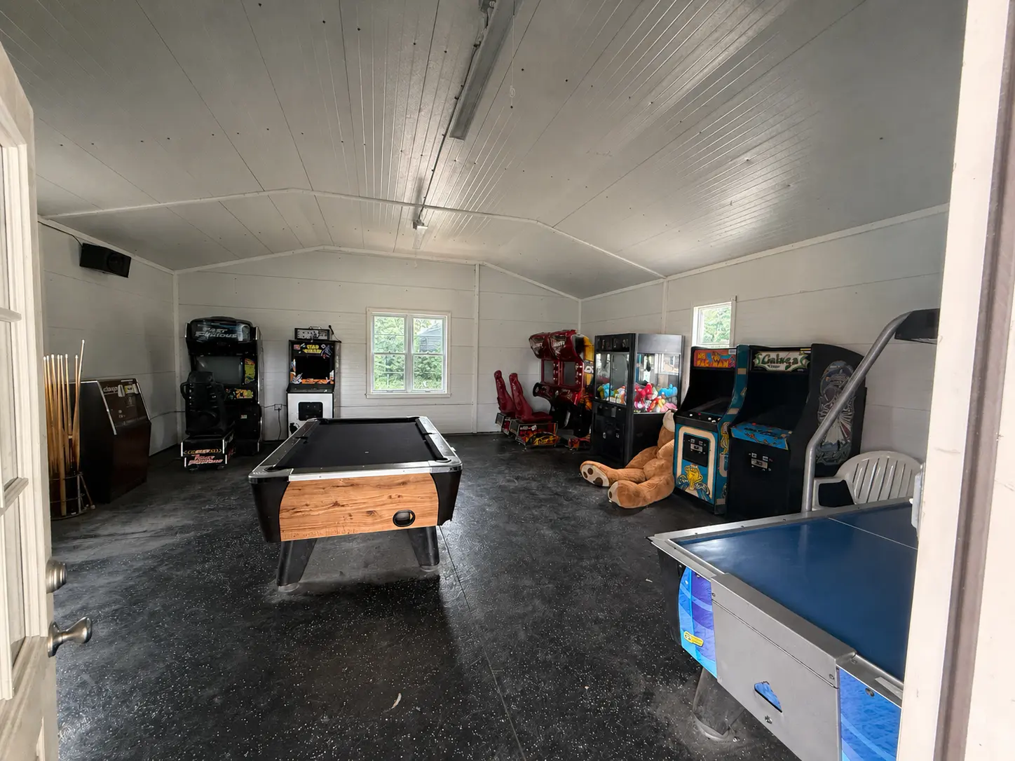 Game room with pool table, air hockey and arcade machines
