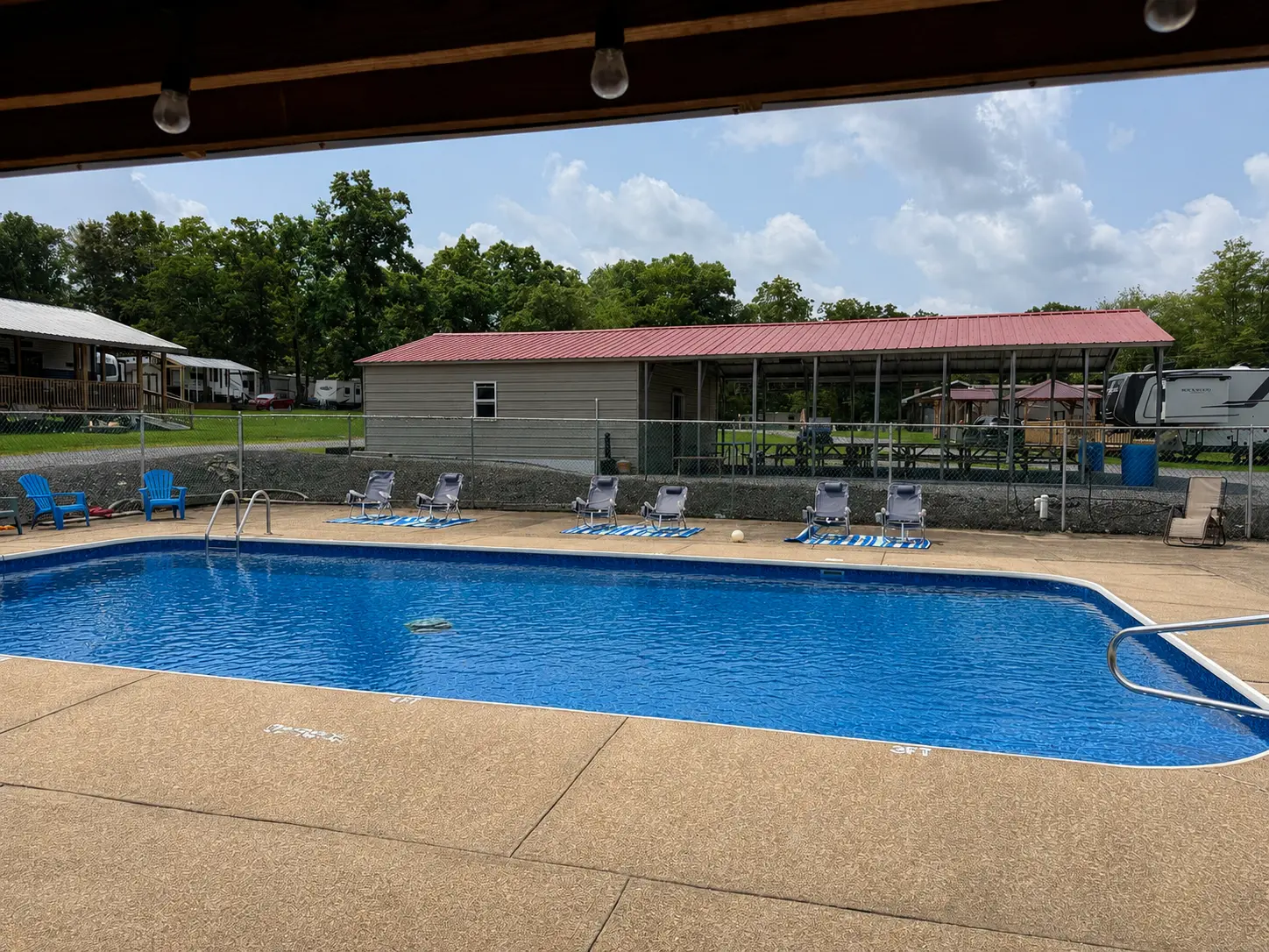 In-ground swimming pool with lounge chairs at Lost Acres
